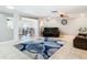 Open living room featuring modern flooring, ceiling fan, and an open layout to the dining area at 5509 Pilots Pl, New Port Richey, FL 34652