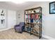 Cozy living room provides wood flooring, a bookshelf, and a chair at 5509 Pilots Pl, New Port Richey, FL 34652