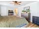 Spacious bedroom featuring wood floors, ceiling fan, dresser, and closet access at 5509 Pilots Pl, New Port Richey, FL 34652