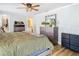 Bright bedroom with ensuite bath, wood floors, ceiling fan, and plenty of storage at 5509 Pilots Pl, New Port Richey, FL 34652