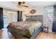 Spacious bedroom featuring wood floors, dark curtains, and a wooden headboard at 5509 Pilots Pl, New Port Richey, FL 34652