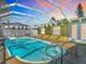 A picturesque screened-in pool under a vibrant sunset, perfect for evening relaxation and enjoyment at 5509 Pilots Pl, New Port Richey, FL 34652