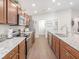 Eat-in kitchen boasting spacious counters, wooden cabinetry, and stainless steel appliances at 6030 Mangrove Creek Rd, Wimauma, FL 33598