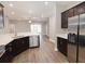 Modern kitchen with stainless steel appliances, dark cabinets and eat-in island at 6058 Barracuda Loop, Wimauma, FL 33598