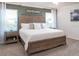 Comfortable bedroom with a large bed, neutral decor, bedside tables, and bright windows at 6949 161St E Ter, Parrish, FL 34219