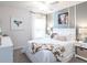 Cozy bedroom with a ceiling fan, stylish decorations, bright windows and a comfortable bed at 6949 161St E Ter, Parrish, FL 34219
