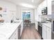 Modern kitchen featuring white cabinets, stainless steel appliances, and a dining area at 6949 161St E Ter, Parrish, FL 34219
