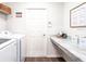 Functional laundry room with counter space, storage shelves, and modern appliances at 6949 161St E Ter, Parrish, FL 34219