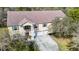 Sprawling two-story home featuring a three car garage, surrounded by lush landscaping and mature trees at 11175 Hyde St, Weeki Wachee, FL 34614