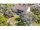 Back exterior view shows multi-level porch and nice backyard surrounded by trees at 11175 Hyde St, Weeki Wachee, FL 34614