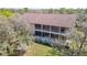 Rear exterior of the home featuring a multi-level porch with a screen and ample space at 11175 Hyde St, Weeki Wachee, FL 34614