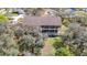 Aerial view showcasing the home's rear exterior with a porch, patio, and backyard at 11175 Hyde St, Weeki Wachee, FL 34614