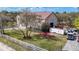 Aerial view of house showing spacious garage, storage and work area, white fencing and lawn at 11175 Hyde St, Weeki Wachee, FL 34614