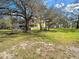 Expansive lawn and a house with a spacious screened porch, creating an ideal outdoor living space at 11175 Hyde St, Weeki Wachee, FL 34614