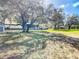 Expansive yard showcasing a home with a screened porch, offering ample space for outdoor activities at 11175 Hyde St, Weeki Wachee, FL 34614
