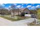 Aerial view of house showing spacious garage, storage and work area, white fencing and lawn at 11175 Hyde St, Weeki Wachee, FL 34614