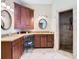 Bathroom with double sink vanity, granite countertop, and decorative mirrors at 11175 Hyde St, Weeki Wachee, FL 34614