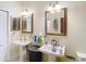 Dual pedestal sinks in a well-lit bathroom create symmetry and functional elegance at 11175 Hyde St, Weeki Wachee, FL 34614