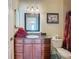 Bathroom featuring a vanity, large mirror and a walk-in shower with neutral tiling at 11175 Hyde St, Weeki Wachee, FL 34614