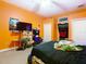 Bedroom with orange walls, ceiling fan, and ample closet space highlighting room's layout at 11175 Hyde St, Weeki Wachee, FL 34614