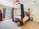 Bright bedroom featuring a wooden canopy bed, a ceiling fan, and lots of natural light at 11175 Hyde St, Weeki Wachee, FL 34614