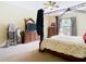 Bedroom with carpet and featuring a wood canopy bed, dresser, and window at 11175 Hyde St, Weeki Wachee, FL 34614