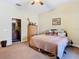 Bedroom featuring neutral carpeted floors, complemented by a ceiling fan for enhanced air circulation at 11175 Hyde St, Weeki Wachee, FL 34614