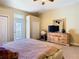 Large bedroom with private balcony door and closet, complemented by matching wooden furniture at 11175 Hyde St, Weeki Wachee, FL 34614