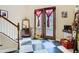 Welcoming foyer with black and white tile floors and ornate wood and glass doors, plus traditional staircase at 11175 Hyde St, Weeki Wachee, FL 34614