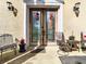 Inviting front porch with charming decor and a decorative patterned glass front door at 11175 Hyde St, Weeki Wachee, FL 34614