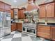 Gourmet kitchen with stainless steel appliances, custom wood cabinets, and striking checkered floors at 11175 Hyde St, Weeki Wachee, FL 34614
