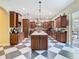 Gourmet kitchen featuring custom cabinetry, granite counters, kitchen island, and stainless steel appliances at 11175 Hyde St, Weeki Wachee, FL 34614