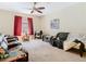 Comfortable living area featuring a ceiling fan, sofas, and natural lighting at 11175 Hyde St, Weeki Wachee, FL 34614