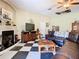 Living room with fireplace, TV, and comfortable seating creates a cozy atmosphere for relaxation and entertainment at 11175 Hyde St, Weeki Wachee, FL 34614