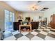 Spacious living room with checkered floors, fireplace, and sliding glass doors to the lanai at 11175 Hyde St, Weeki Wachee, FL 34614