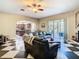 Open-concept living room with access to the kitchen and lanai, perfect for entertaining and enjoying indoor-outdoor living at 11175 Hyde St, Weeki Wachee, FL 34614