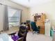 Well-lit home office features neutral walls, large windows, and functional desk and storage at 11175 Hyde St, Weeki Wachee, FL 34614