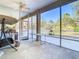 This screened patio features large windows offering tranquil views of the surrounding landscape at 11175 Hyde St, Weeki Wachee, FL 34614
