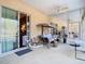 Relaxing screened patio includes a patio swing, ceiling fan, and access to both the interior and the outdoors at 11175 Hyde St, Weeki Wachee, FL 34614