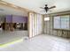Renovated living room with tiled floor, ceiling fan, and views of a renovated room at 4745 Floramar Ter, New Port Richey, FL 34652