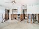 Large living room under construction with visible framing and an open floor plan at 4745 Floramar Ter, New Port Richey, FL 34652
