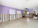 Open-concept living room with view to kitchen, ceiling fan, and partially exposed wall frames at 4745 Floramar Ter, New Port Richey, FL 34652