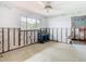 Partially renovated room featuring a large window, ceiling fan, and restoration equipment at 4745 Floramar Ter, New Port Richey, FL 34652