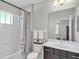 Bathroom with a shower/bath combo, large mirror, and neutral colors at 7048 White Willow Ct, Sarasota, FL 34243