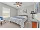 Bright bedroom with neutral walls, a ceiling fan, and decoratively framed artwork at 7048 White Willow Ct, Sarasota, FL 34243