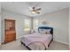 Comfortable bedroom with blue bed frame, dresser, neutral walls and carpet, with natural light at 7048 White Willow Ct, Sarasota, FL 34243