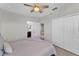 Well-lit bedroom features a ceiling fan, ensuite bathroom, and closet for ample storage at 7048 White Willow Ct, Sarasota, FL 34243