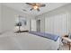 Well-lit bedroom with ceiling fan and a full bed situated between a closet and an end table at 7048 White Willow Ct, Sarasota, FL 34243