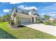 Well-kept two-story home with a two-car garage, mature landscaping, and a manicured lawn at 7048 White Willow Ct, Sarasota, FL 34243