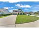 Two-story home featuring a manicured lawn, a two-car garage, and well-maintained landscaping at 7048 White Willow Ct, Sarasota, FL 34243